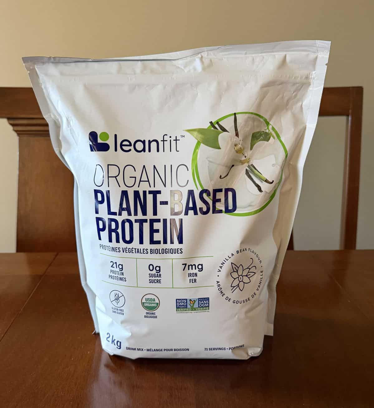Image of the Costco Leanfit Organic Plant-Based Vanilla Protein Powder bag sitting on a table unopened.