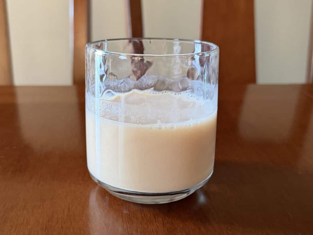 Side view image of a prepared vanilla protein shake.