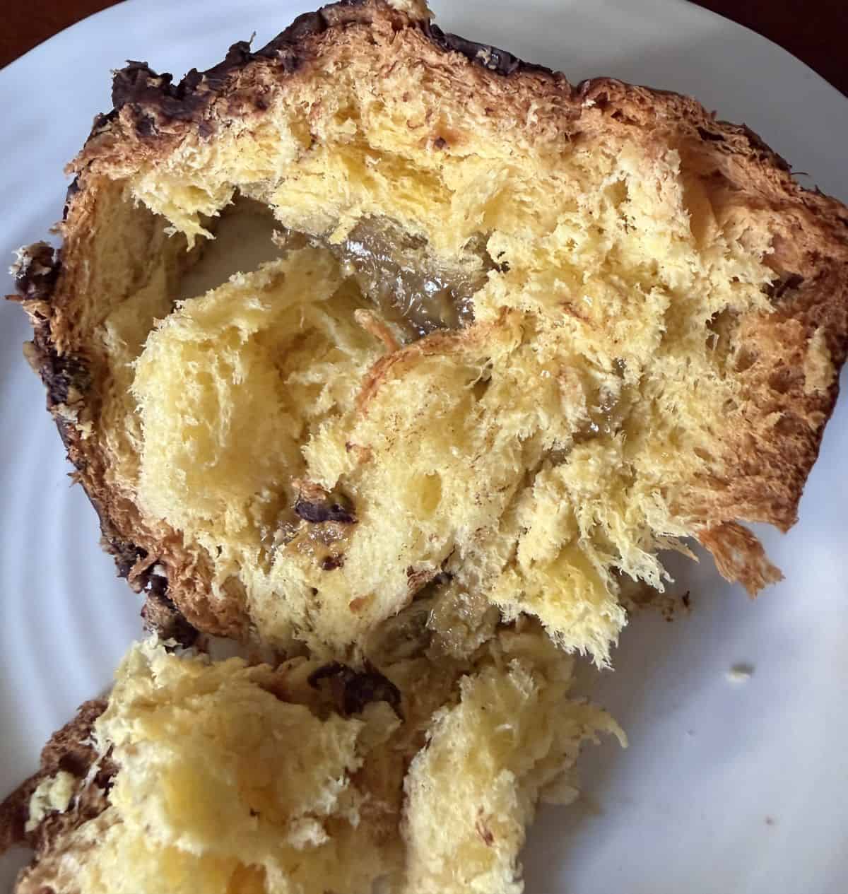 Closeup image of one piece of panettone showing the pistachio cream. 