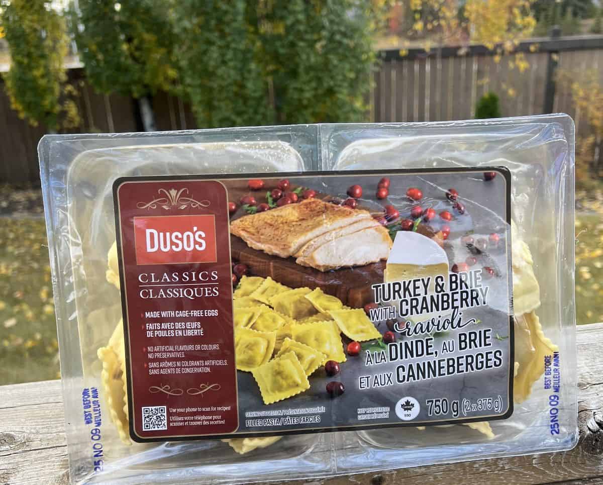 Image of the Costco Duso's Turkey & Brie with Cranberry Ravioli package sitting on a table unopened. 