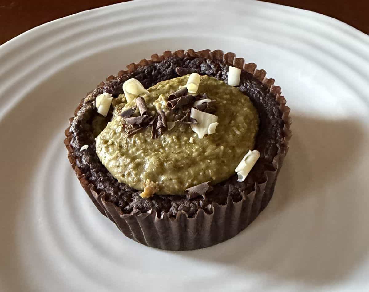 Closeup side view image of one Dubai style brownie served on a white plate.