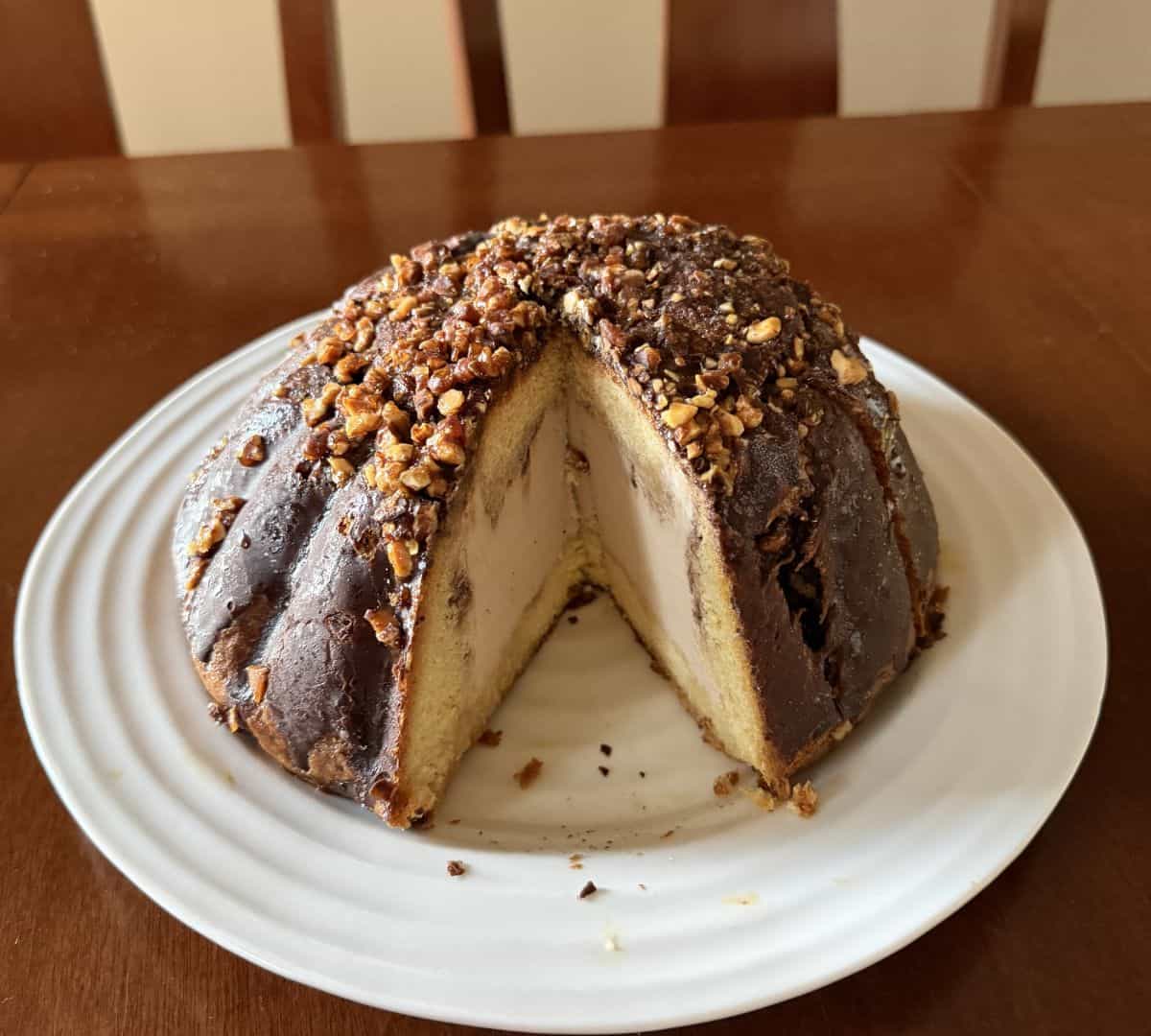 Image of the entire cake with a piece sliced out of it so you can see what the inside of the cake looks like.