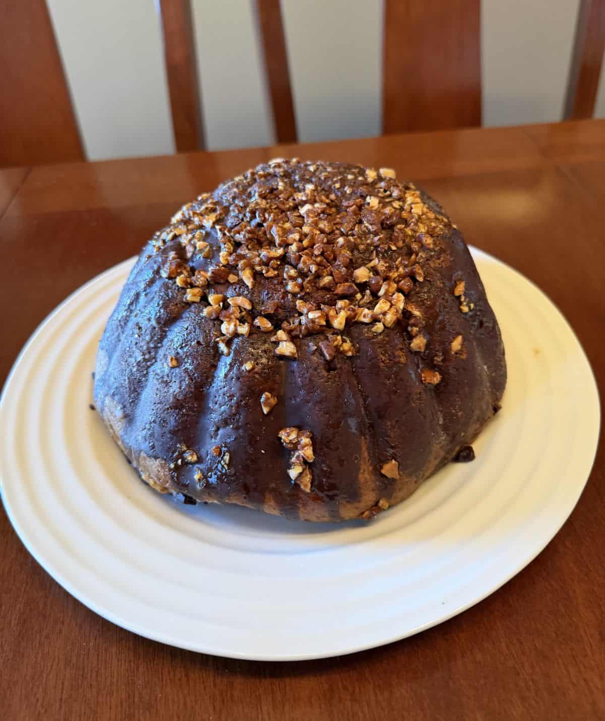 Image of the entire ice cream cake served on a white plate before slicing it.