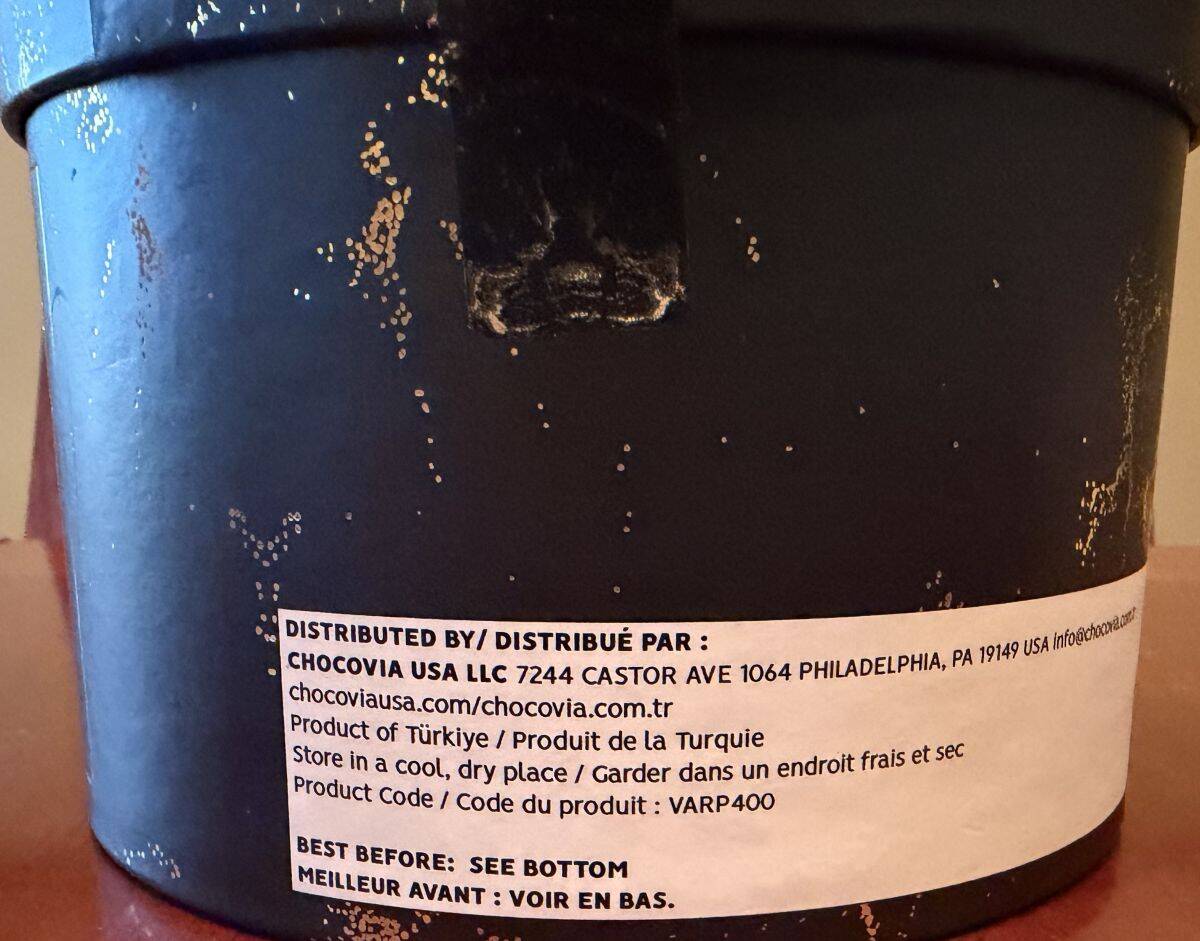 Image of where the chocolates are produced and storage instructions from the container.