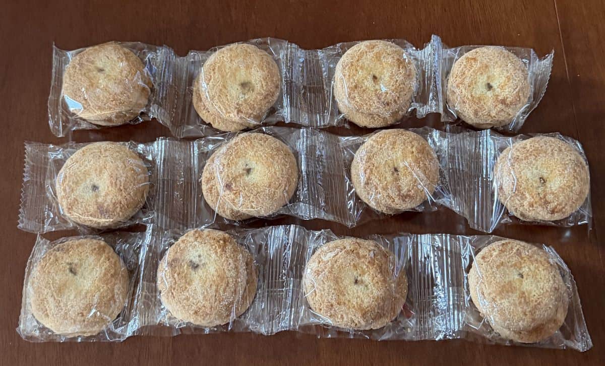 Image of three plastic sleeves with four cookies in each sleeve sitting on a table. 