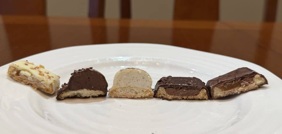 Image of five different kinds of biscuits cut in half and on a white plate so you can see the center.