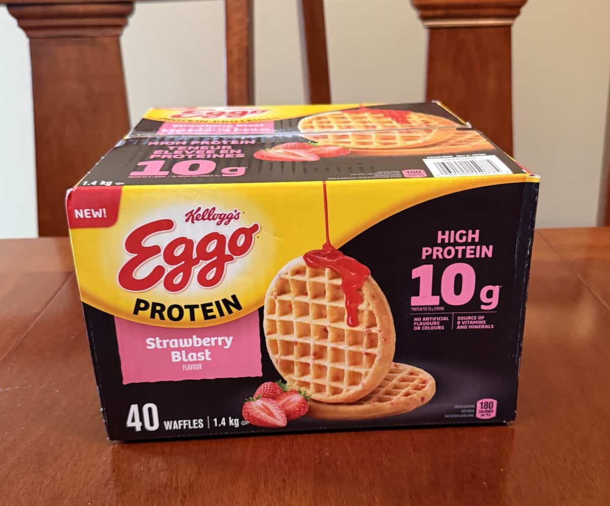 Image of the box of Costco Kellogg's Eggo Protein Waffles sitting on a table unopened.