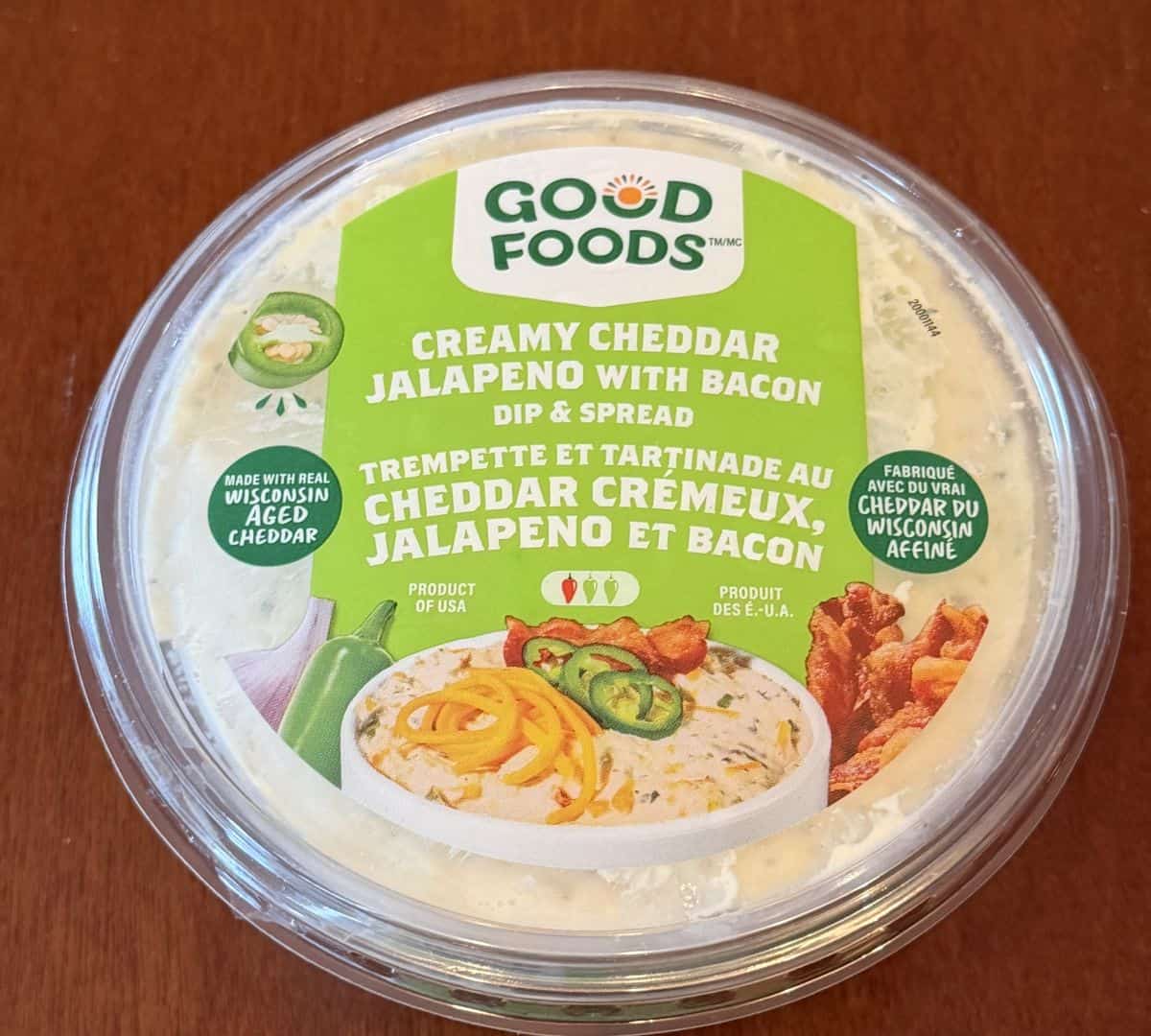 Top down image of the lid on the dip showing that it's made with real Wisconsin aged cheddar and is a product of USA.