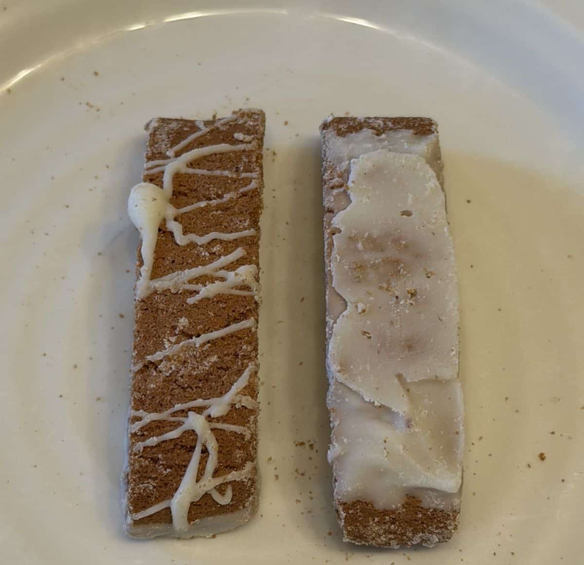 Top down image of two biscotti bites served on a white plate.