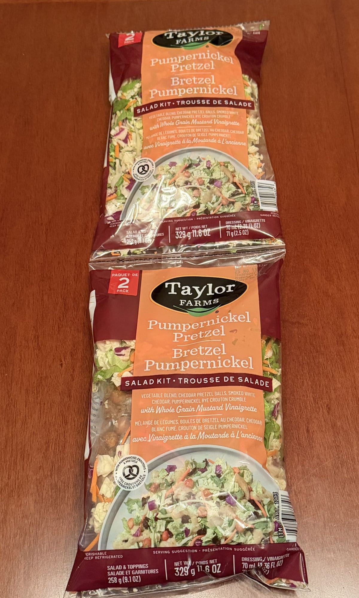 Image of the two-pack of the Costco Taylor Farms Pumpernickel Pretzel Salad Kit sitting on a table unopened.