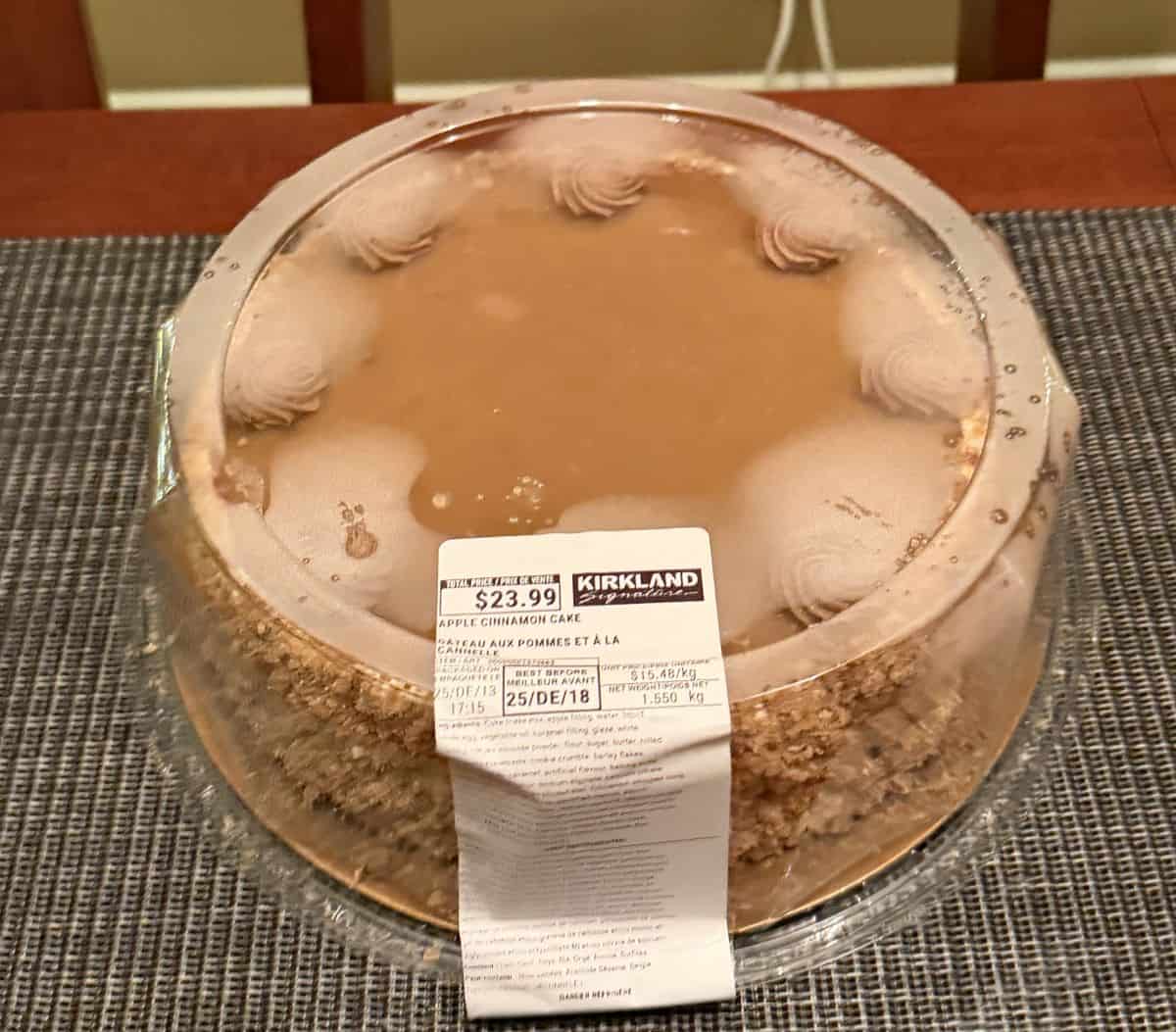 Image of the Costco Kirkland Signature Apple Cinnamon Cake sitting on a table unopened.
