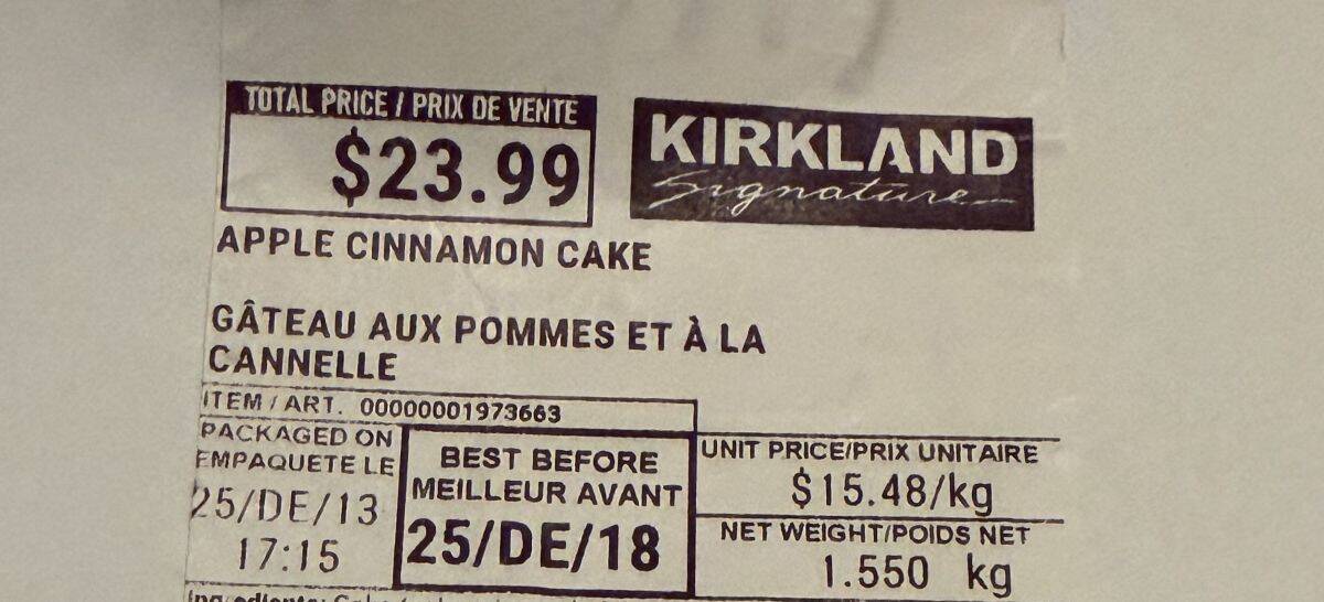 Closeup image of the label on the cinnamon apple cake showing the cost and expiry date for the cake.