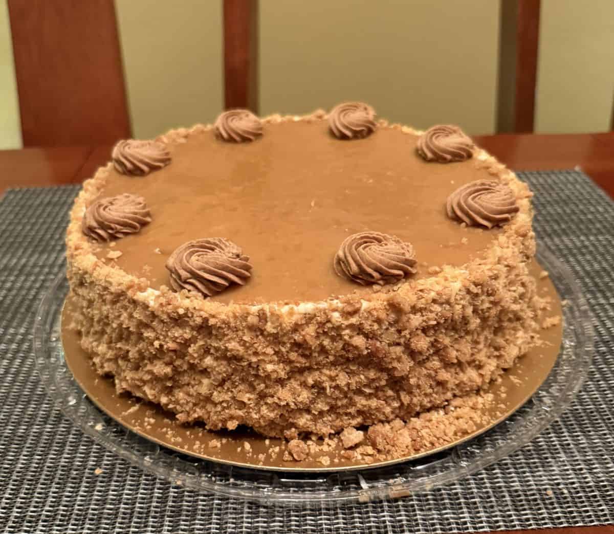 Closeup image of the cinnamon apple cake sitting on a table with the lid off before being served