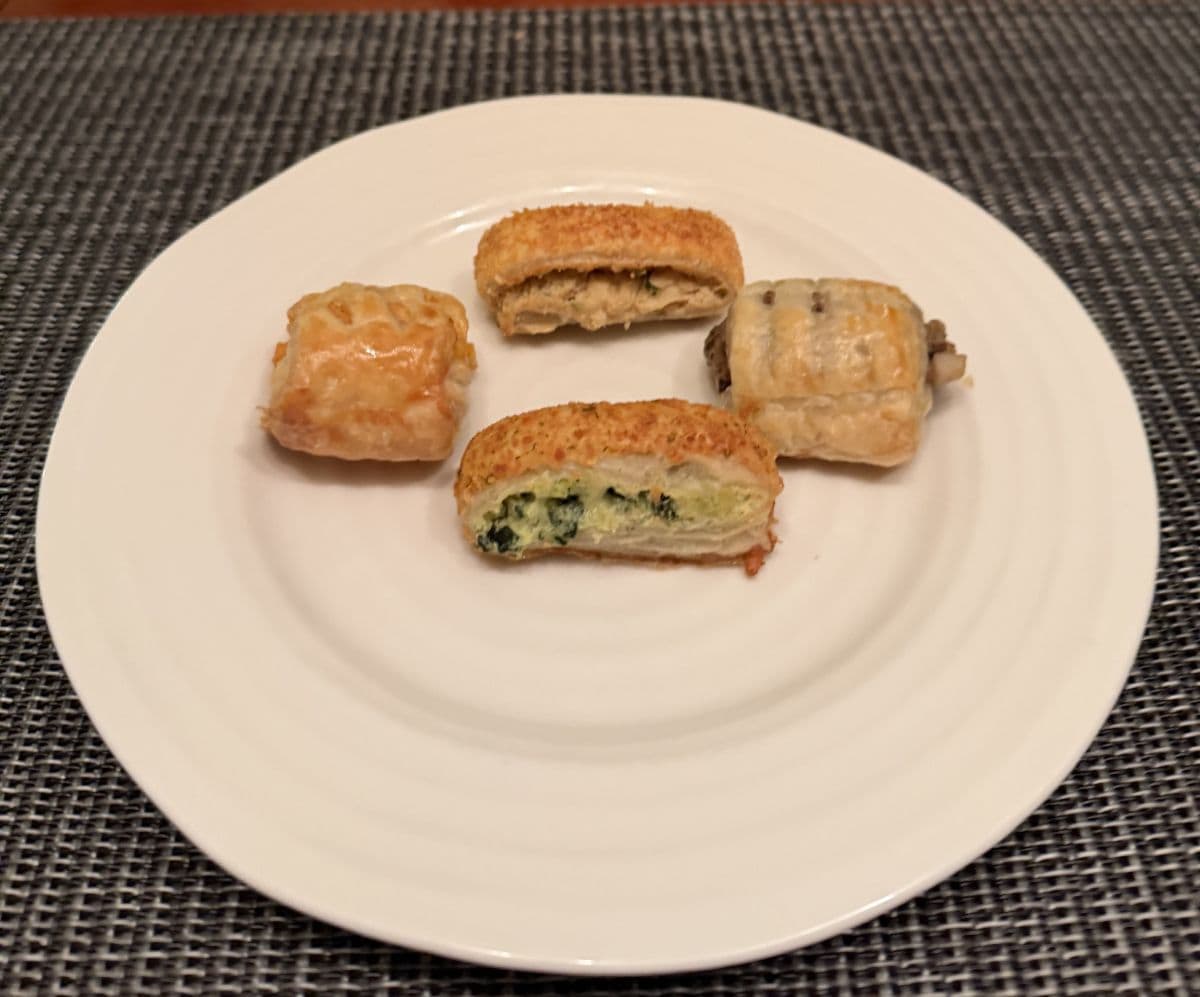Image of four puff pastry baked and served on a white plate.