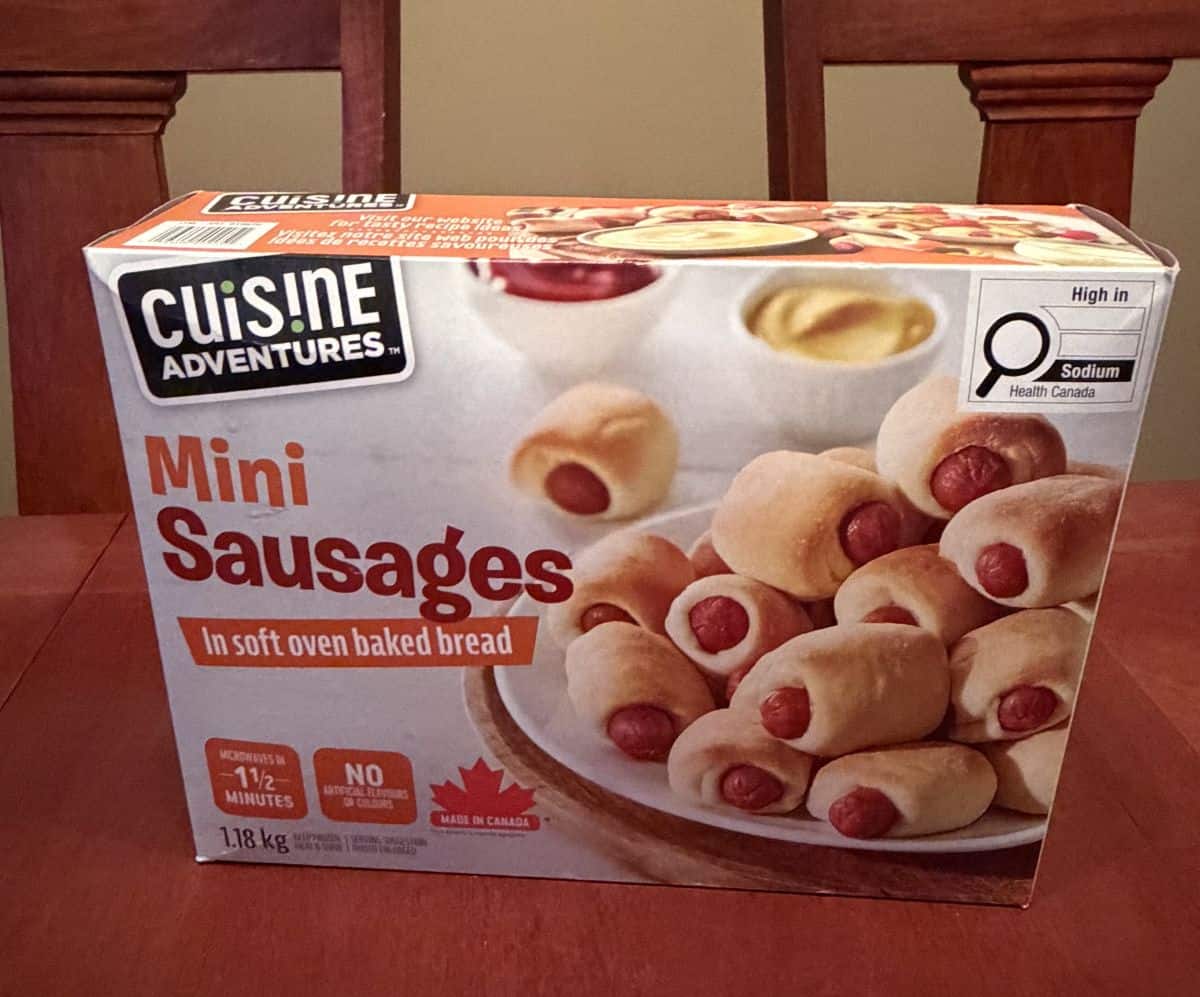 Image of the Costco Cuisine Adventures Mini Sausages box sitting on a table unopened.