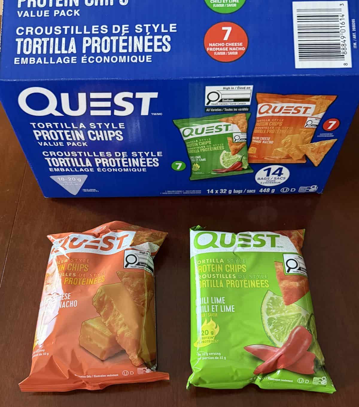 Image of two bags of Quest Protein Chips, chili lime and nacho cheese laying on a table unopened.