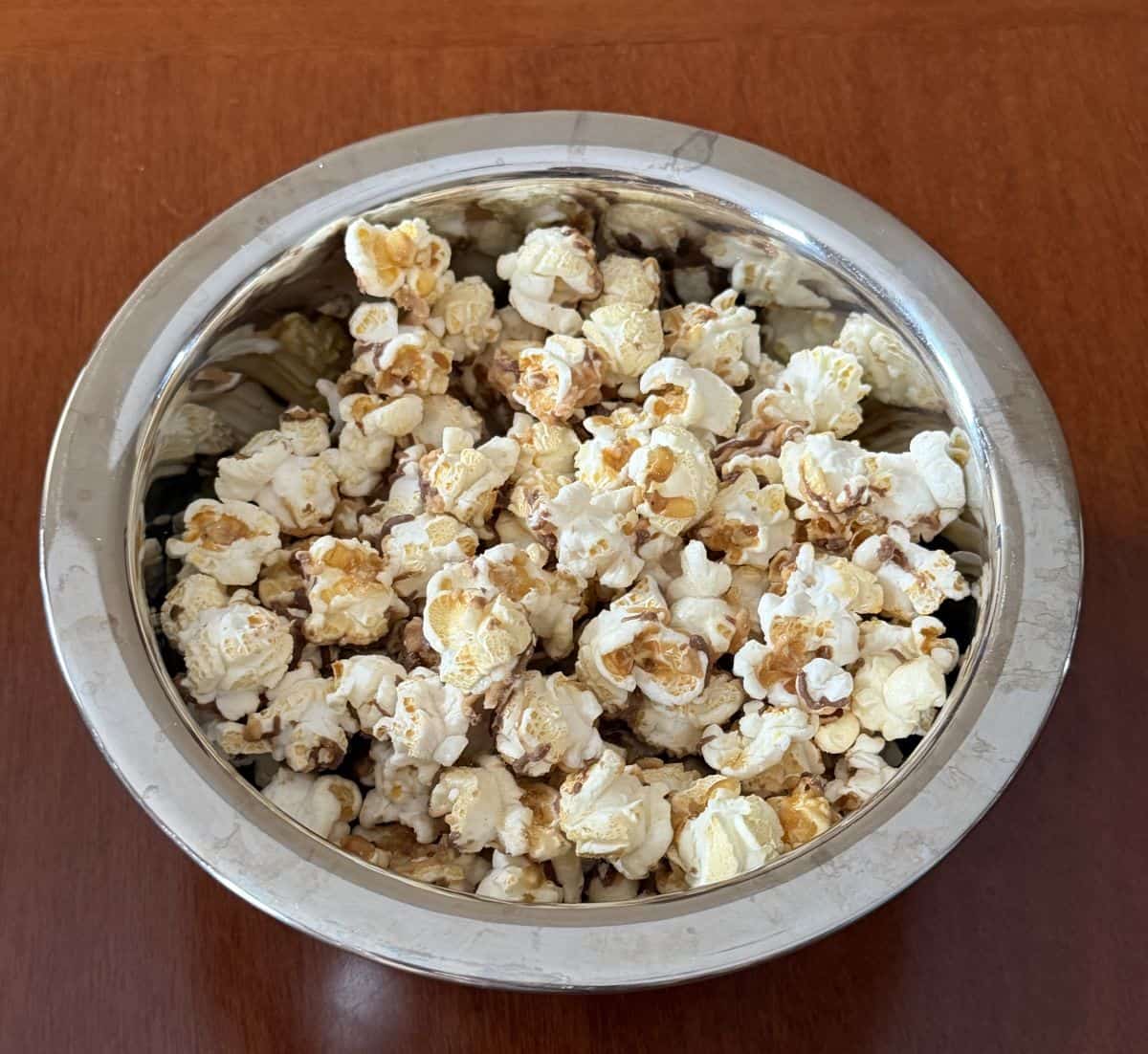 Closeup top down image of a bowl of Reese's popcorn.
