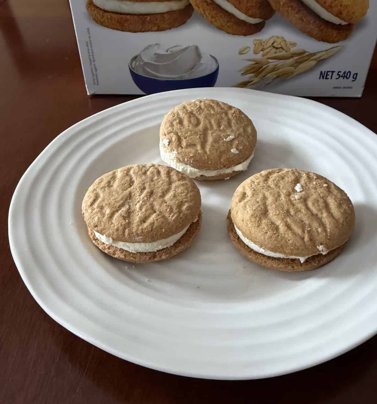 Top down image of three cookies served on a white plate.