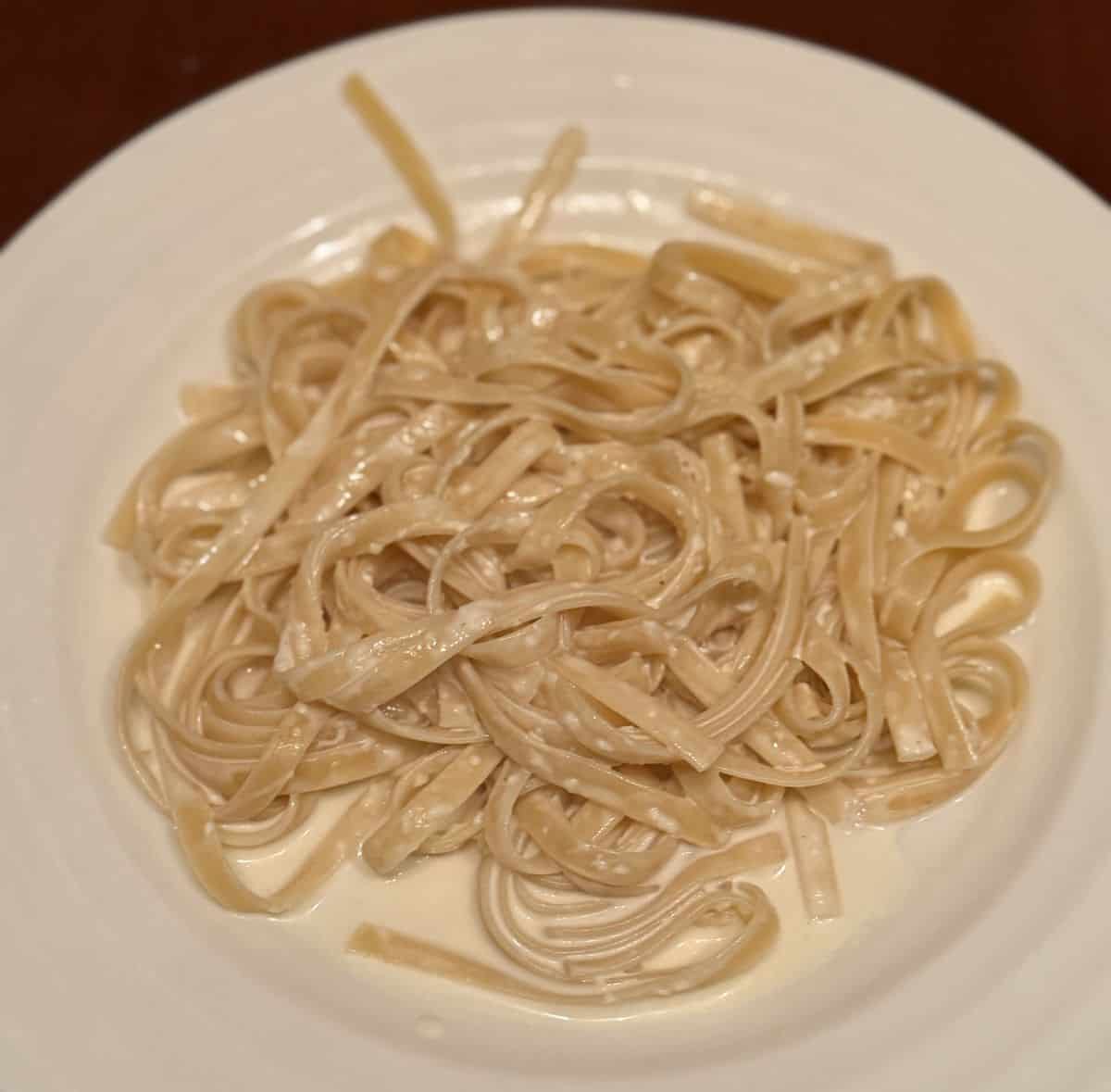 Top-down image of a plate of Fettucine Alfredo. 