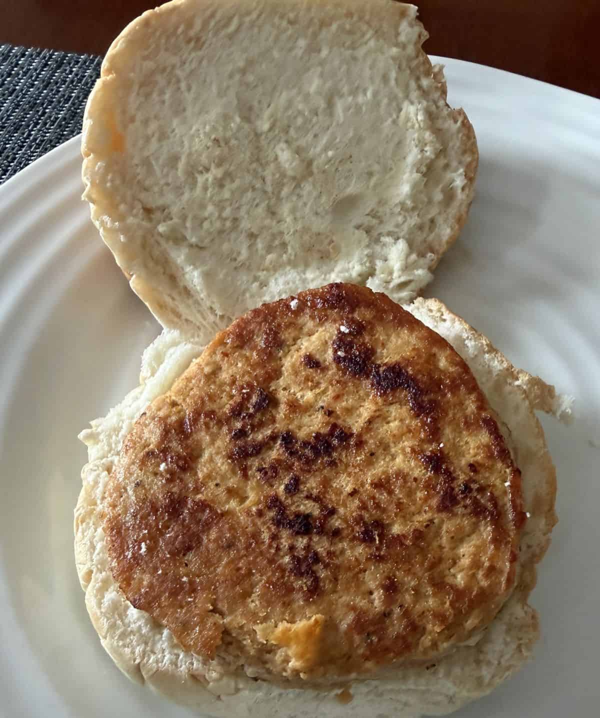 Image of a chicken burger cooked and served on a open-faced bun.