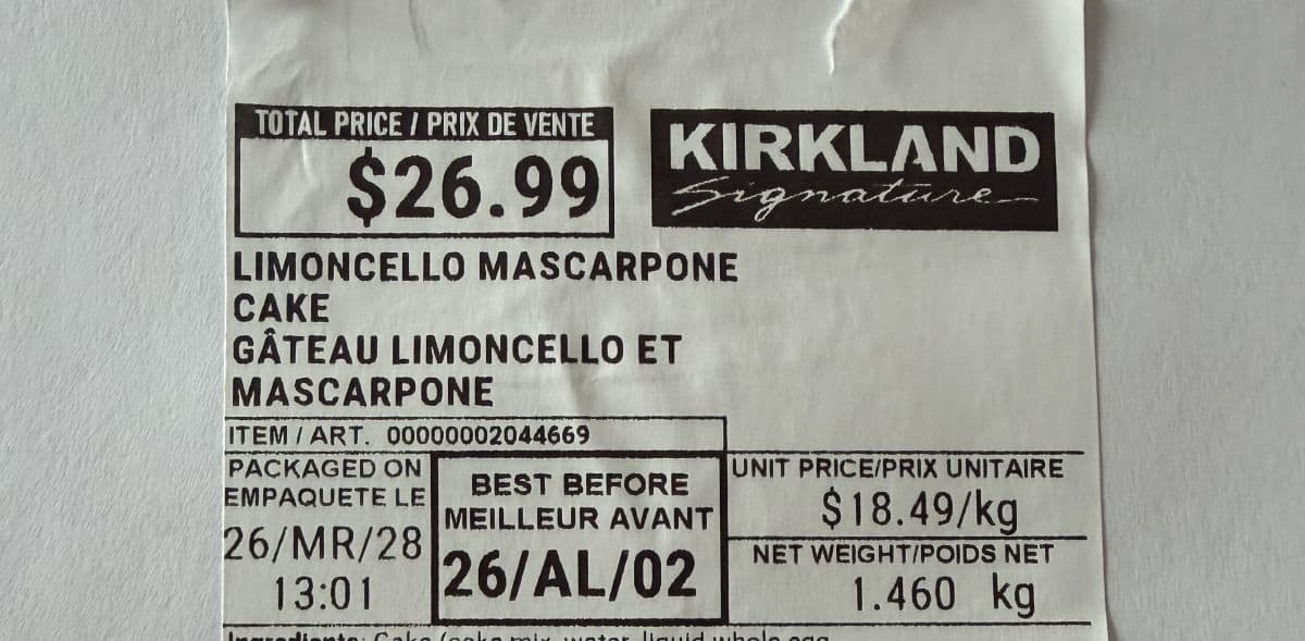 Image of the label from the cake showing the best before date and the cost.