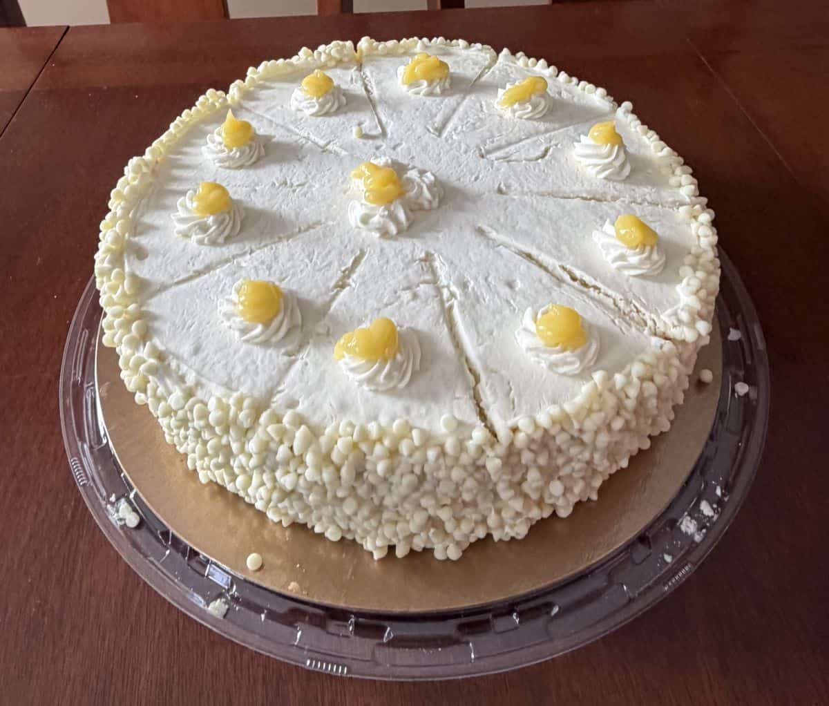 Top down image of the cake with the lid off showing what the top and side of the cake looks like before cutting it.