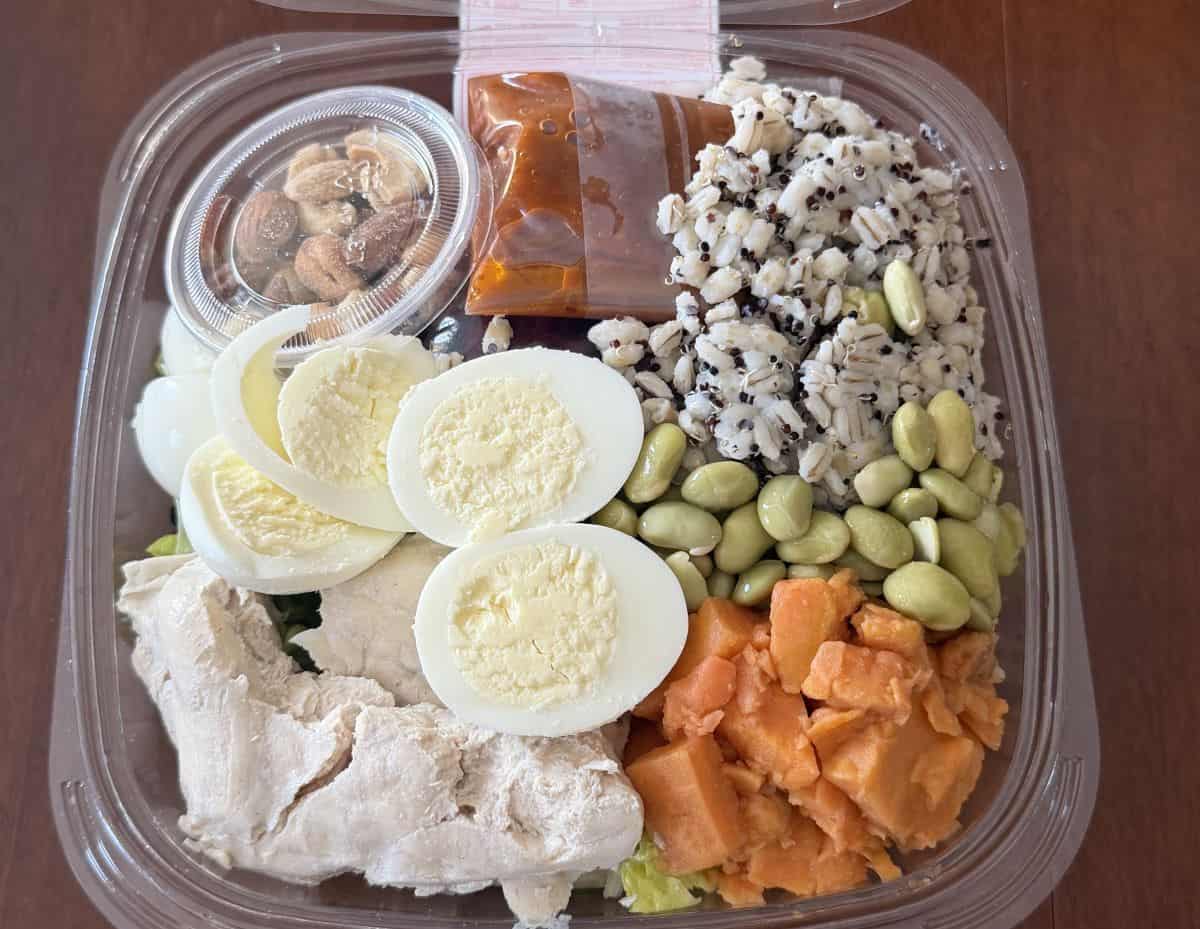Top down image of the salad with the lid off so you can see all the different ingredients and components inside.