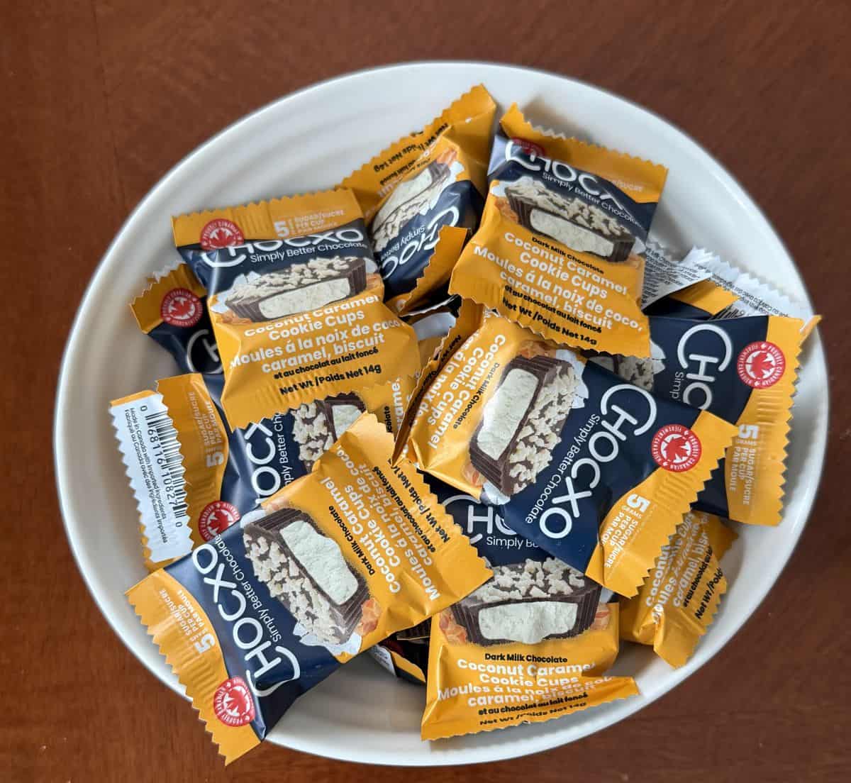 Image of a bowl of individually wrapped chocolate cups served in a white bowl.
