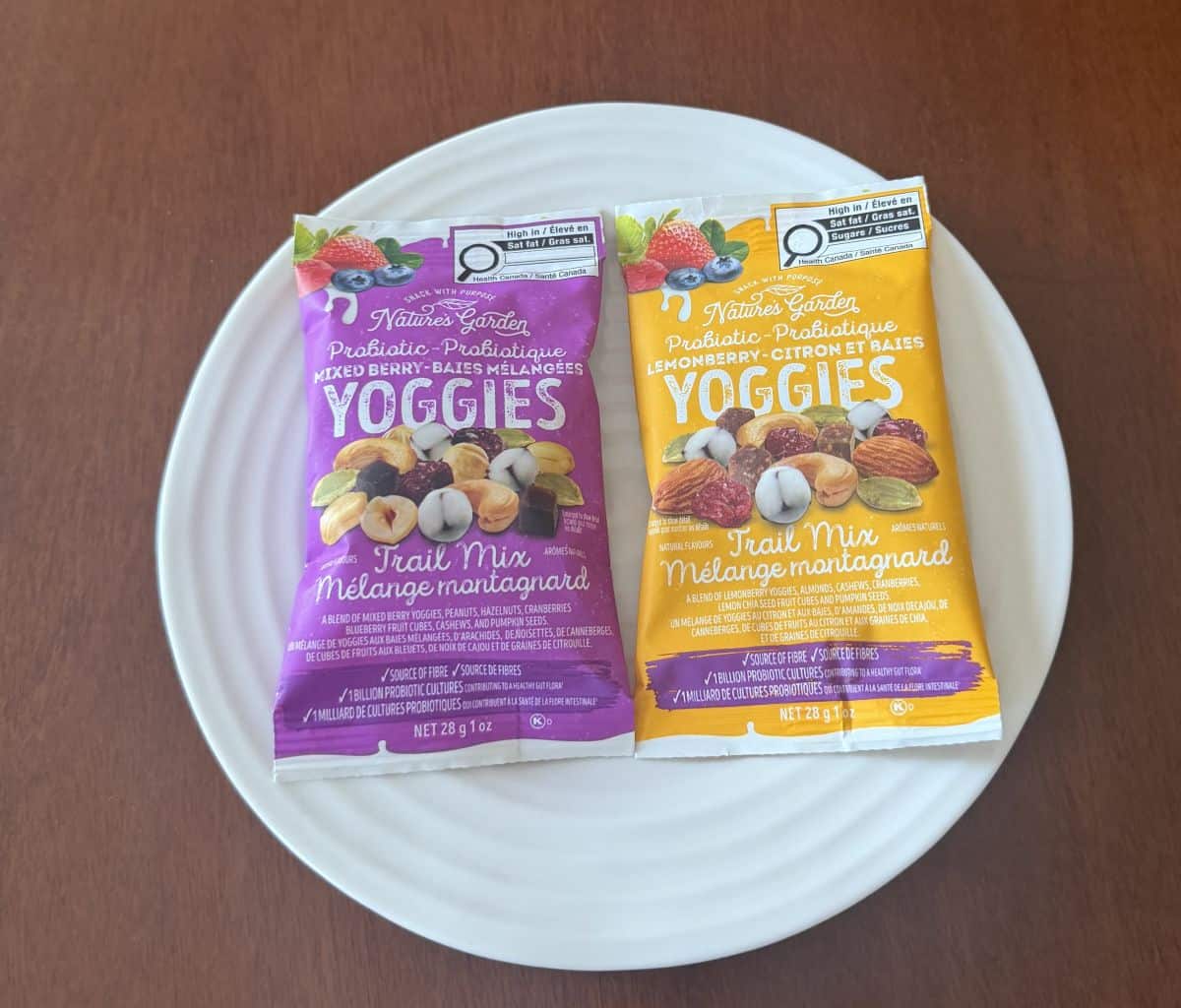 Image of one lemon berry and one mixed berry trail max package sitting on a white plate unopened.