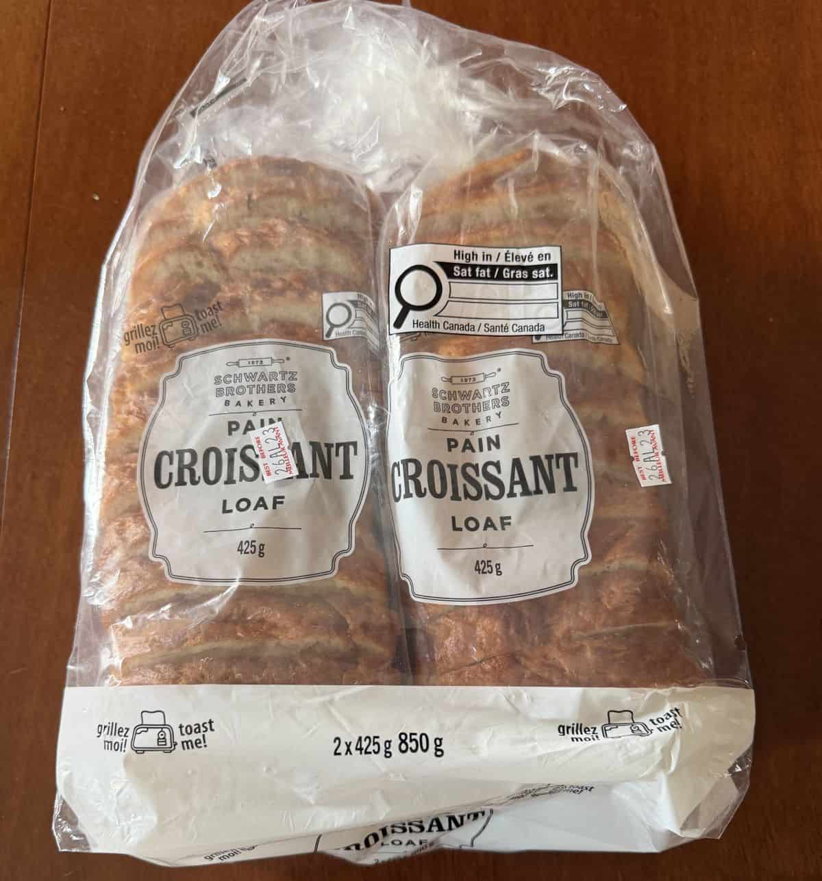 Image of the Costco Schwartz Brothers Bakery Pain Croissant Loaf two-pack sitting on a table unopened.