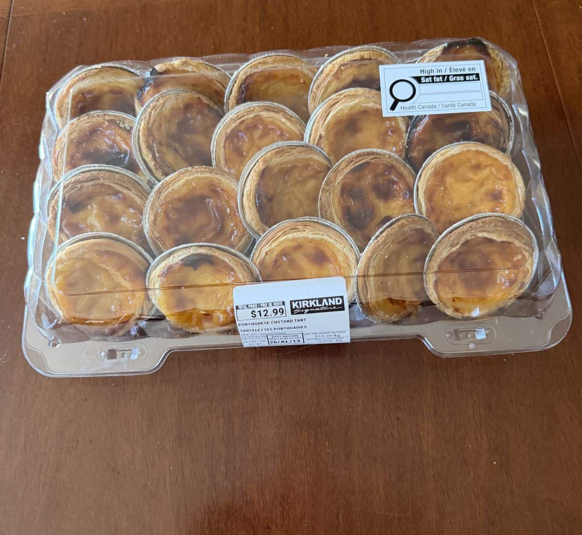 Image of the Costco Kirkland Signature Portuguese Custard Tart package sitting on a table unopened.