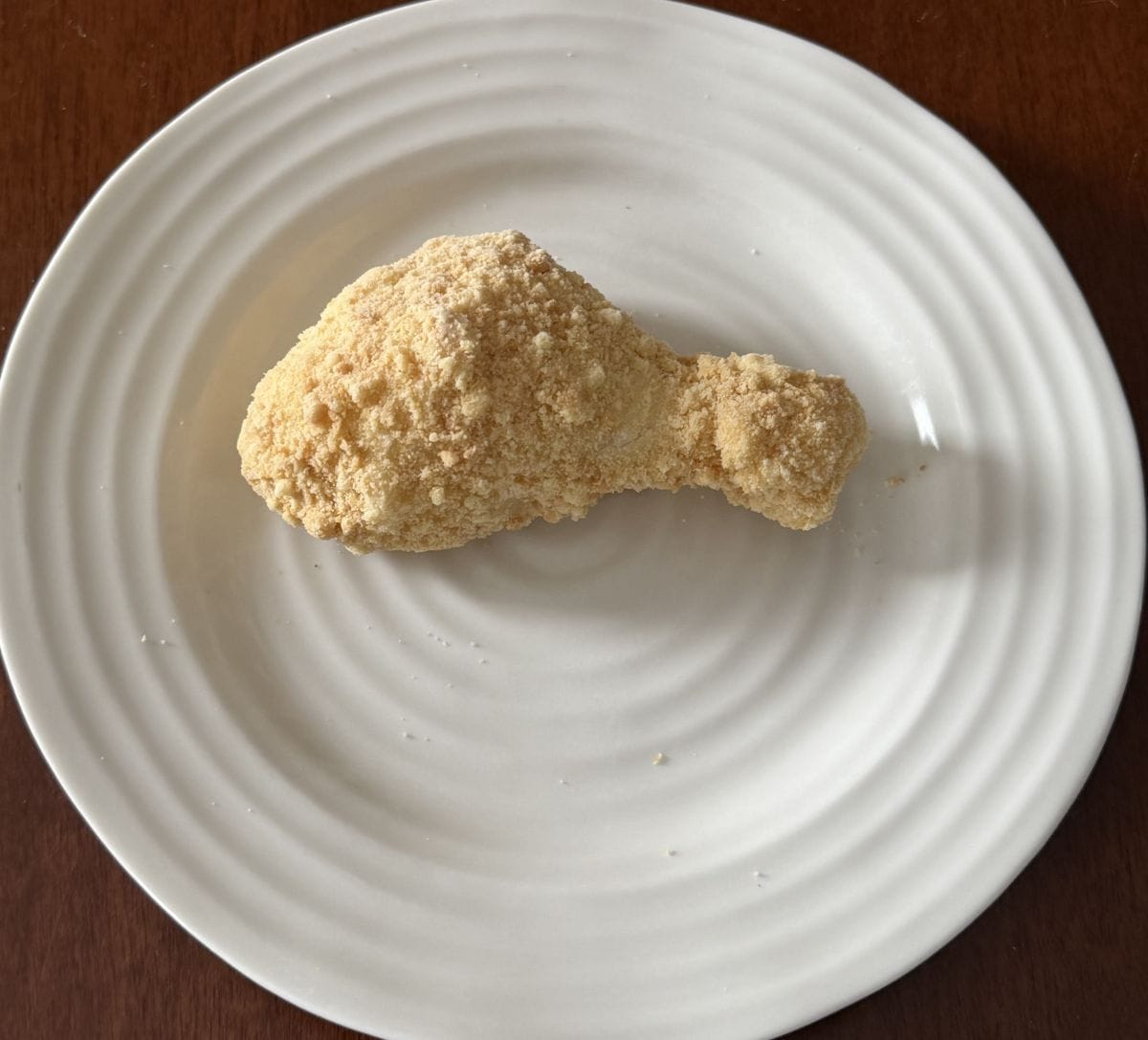 Top down image of one drumstick dessert served on a white plate.
