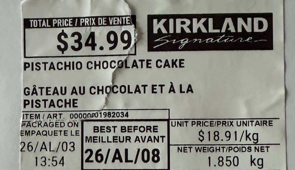 Closeup image of the front label of the Kirkland Signature Pistachio Chocolate Cake showing the cost and expiry date.