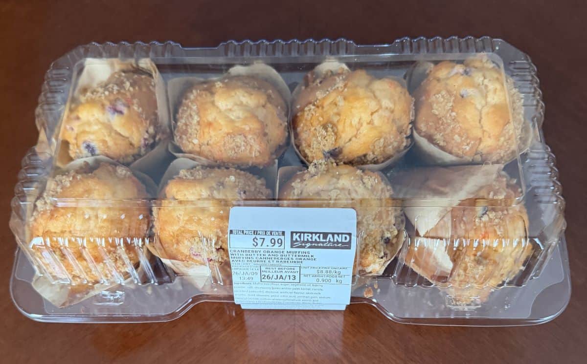Image of an eight pack of the Kirkland Signature Cranberry Orange Muffins with Butter and Buttermilk sitting on a table unopened.