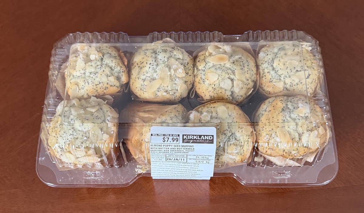 Image of an eight pack of the Kirkland Signature Almond Poppy Seed Muffins with Butter and Buttermilk sitting on a table unopened.