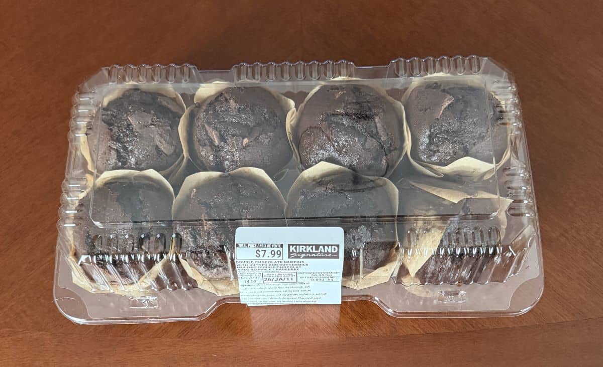 Image of an eight pack of the Kirkland Signature Double Chocolate Muffins with Butter and Buttermilk sitting on a table unopened.