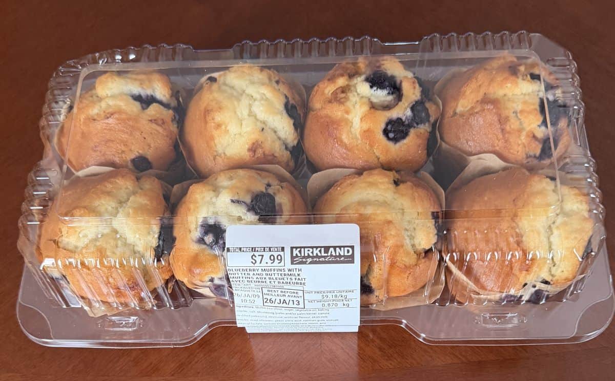 Image of an eight pack of the Kirkland Signature Double Blueberry Muffins with Butter and Buttermilk sitting on a table unopened.
