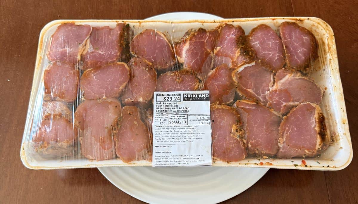 Image of the Costco Kirkland Signature Maple Chipotle Pork Tenderloin Medallions sitting on a table unopened and raw.