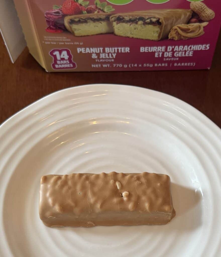 Image of one unwrapped protein and fibre bar served on a white plate.