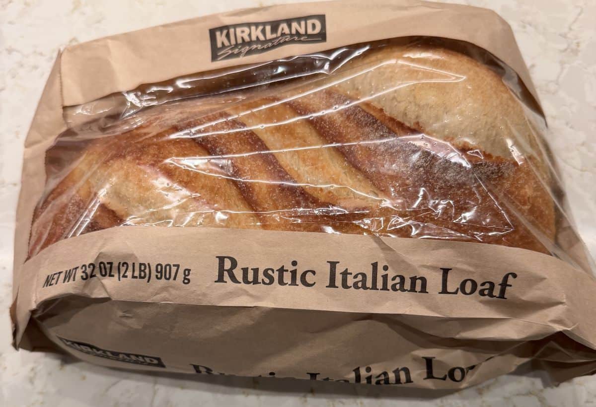 Image of the Costco Kirkland Signature Rustic Italian Loaf sitting on a counter in the package unopened.