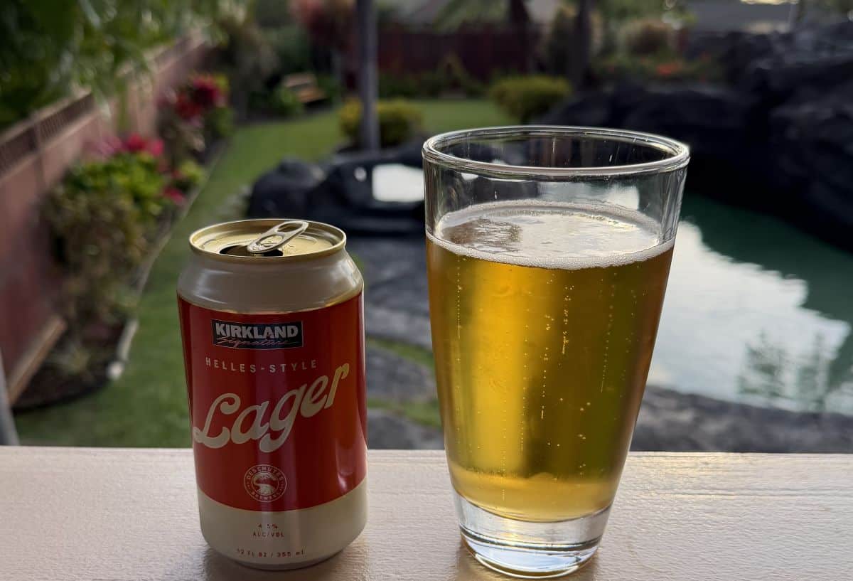 Image of a beer can beside a glass of beer.