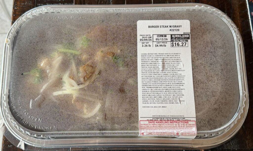 Image of the Costco Kirkland Signature Burger Steak with Gravy Meal sitting on a table unopened.
