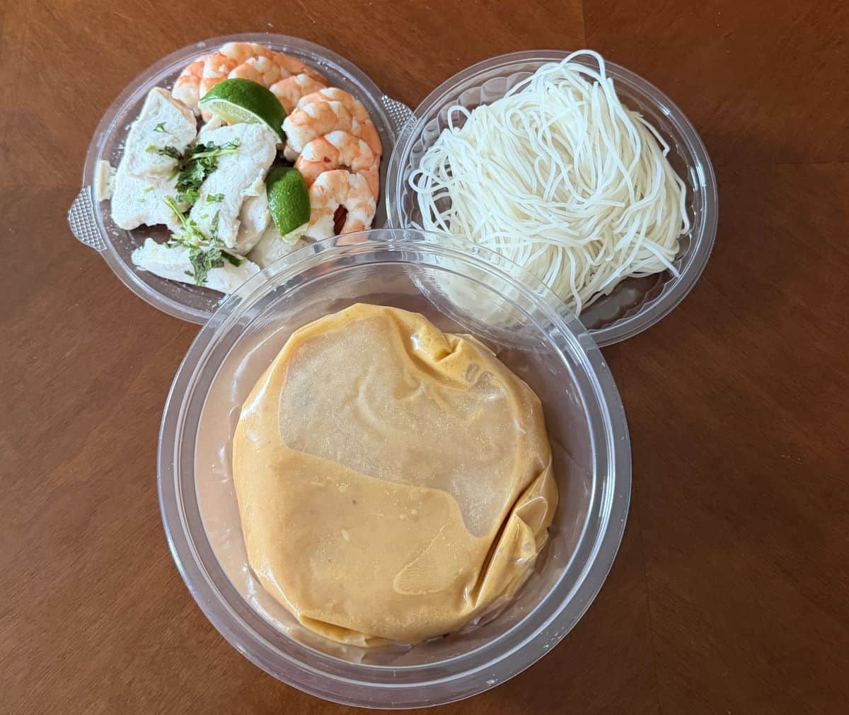 Top down image of all the components that come in the Kirkland Signature Tom Yum Soup kit.