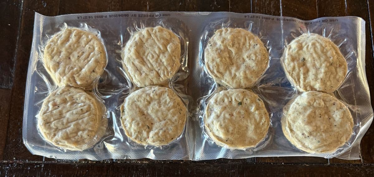 Image of the chicken patties vacuum sealed, unopened, sitting on a table.