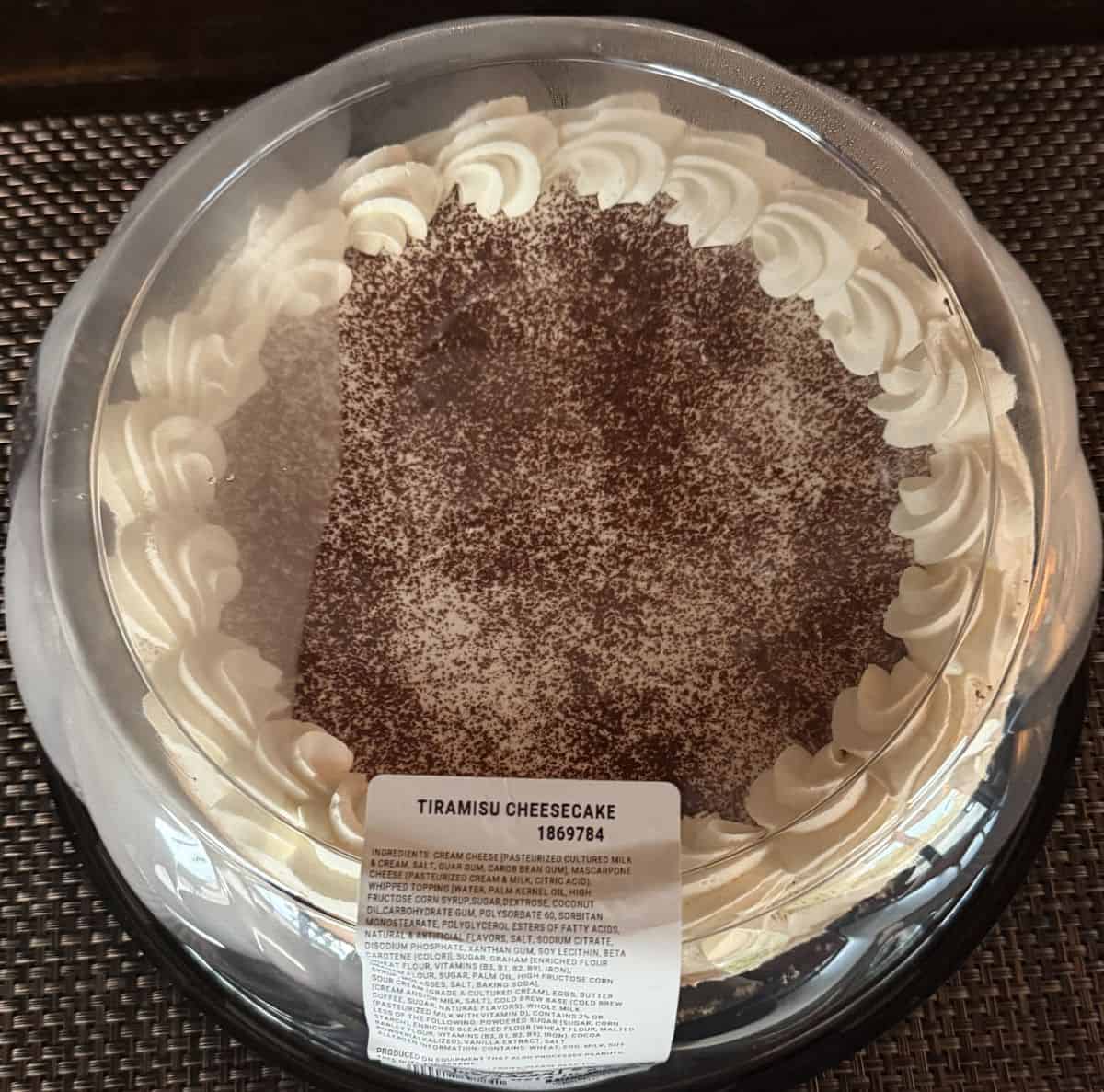 Image of the Costco Kirkland Signature Tiramisu Cheesecake unopened and sitting on a table.