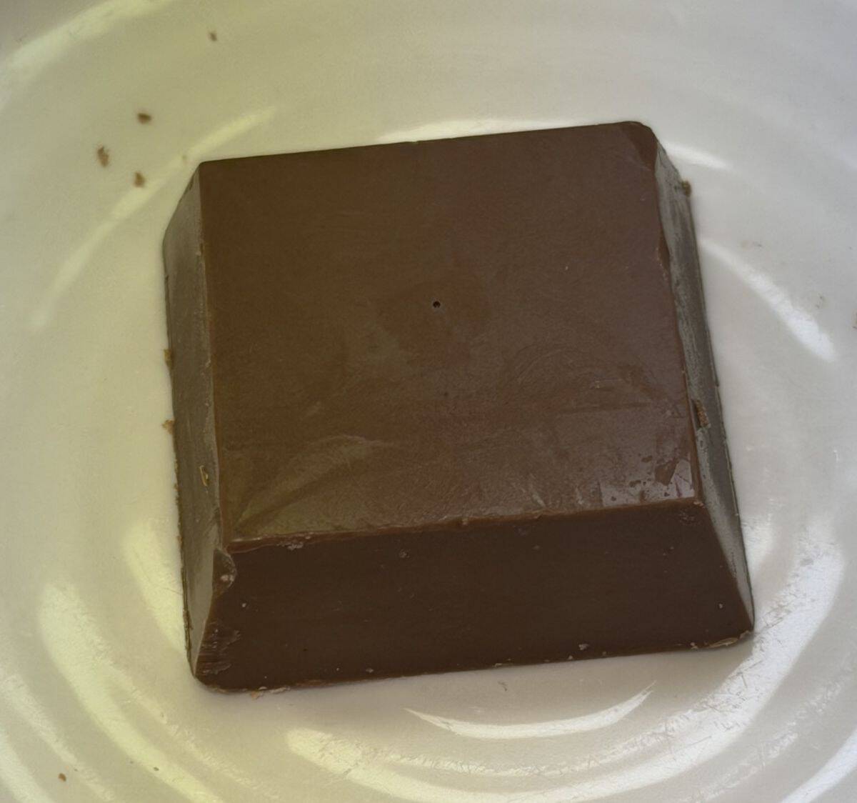 Image of one chocolate unwrapped and served on a white plate.