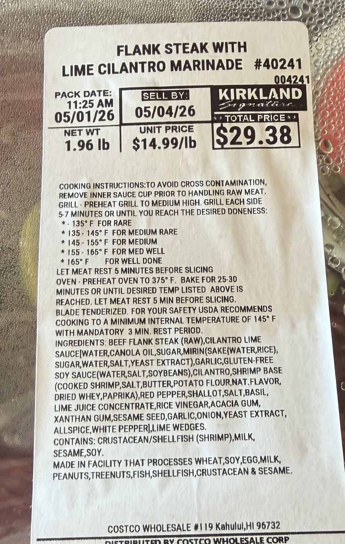 Closeup image of the label on the flank steak with marinade showing cooking instructions, sell by date, cost and ingredients.
