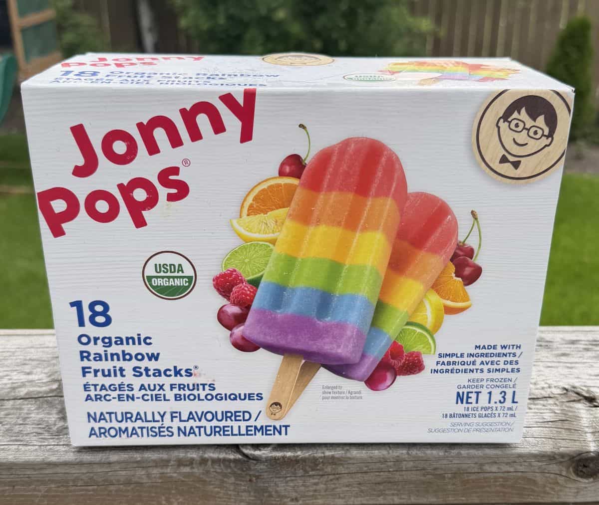 Image of the Costco Jonny Pops Organic Rainbow Fruit Stacks box sitting on a deck outside unopened.