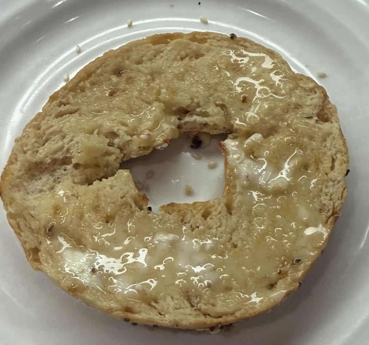 Top down image of half a protein bagel toasted with butter.