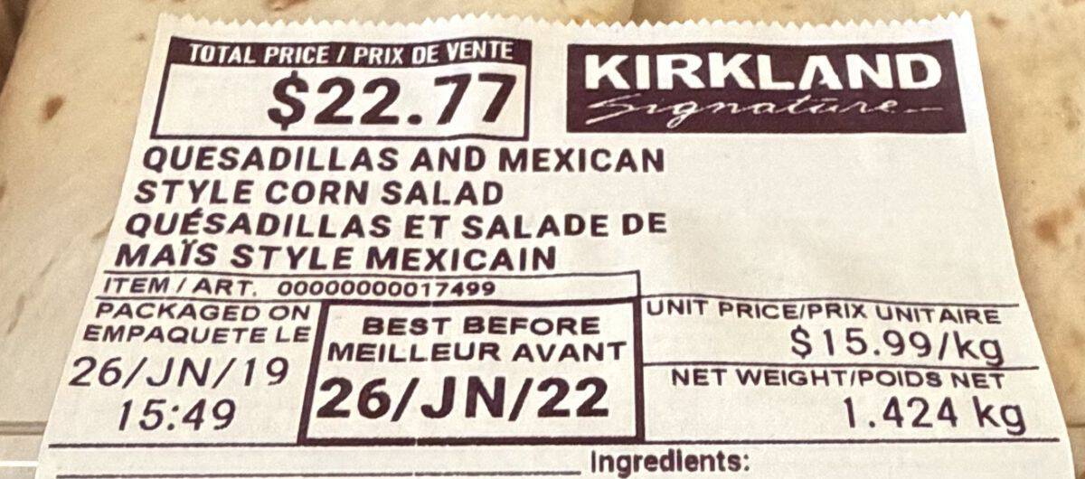 Closeup image of the label on the quesadillas and corn salad showing best before date and cost.